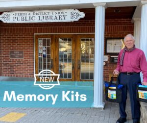 man holding two bags outside a public library