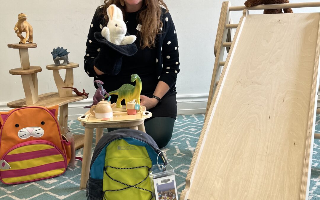 Women sits on carpet with toys around her