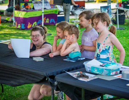 Heidi, children's librarian, stands with thank you letter from kindergarten class
